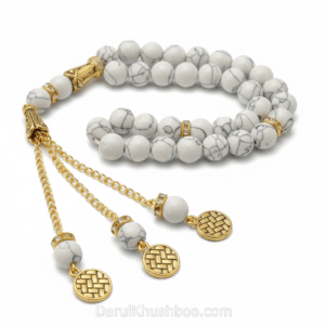 Close-up of a Premium White Feroza Stone Tasbih with 33 beads on a white silk cloth.